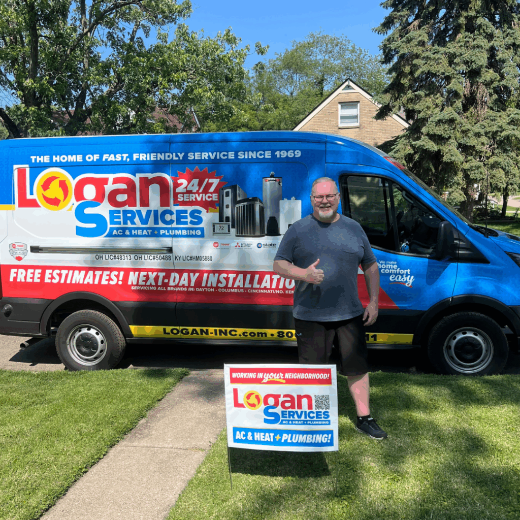 Customer posing with thumbs up in front of the Logan Services van with their yard sign.