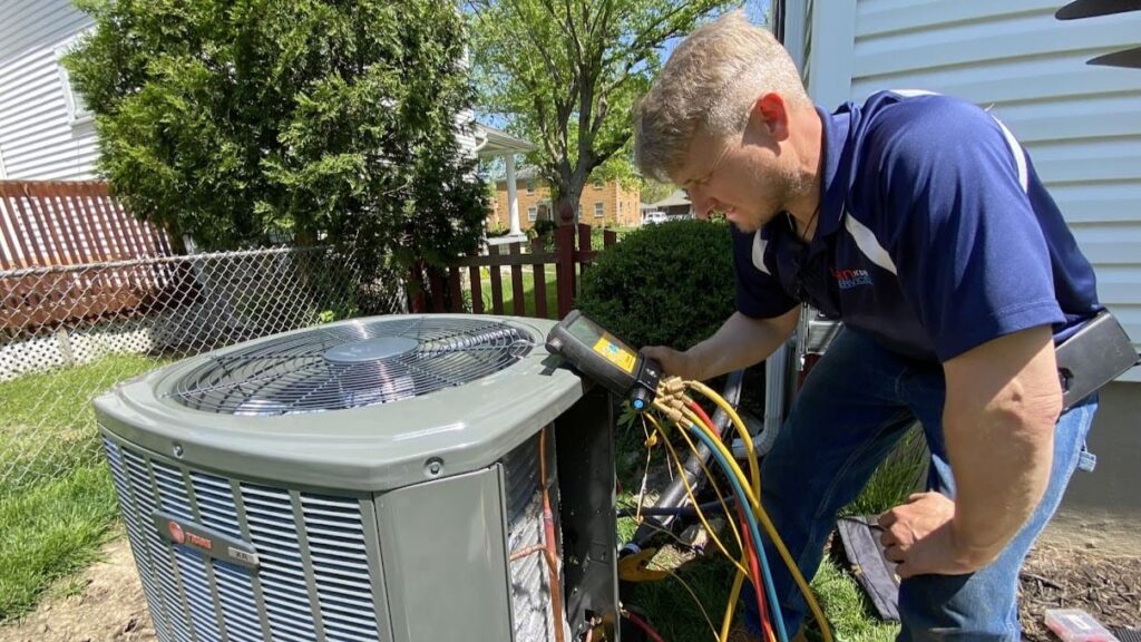 Logan Services HVAC technician installing Trane AC unit