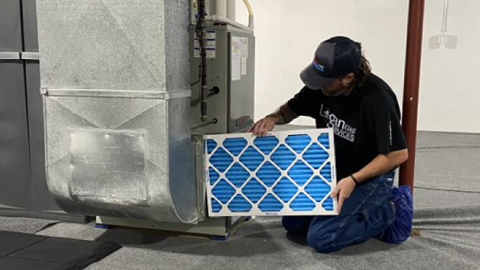 HVAC tech replacing air filter