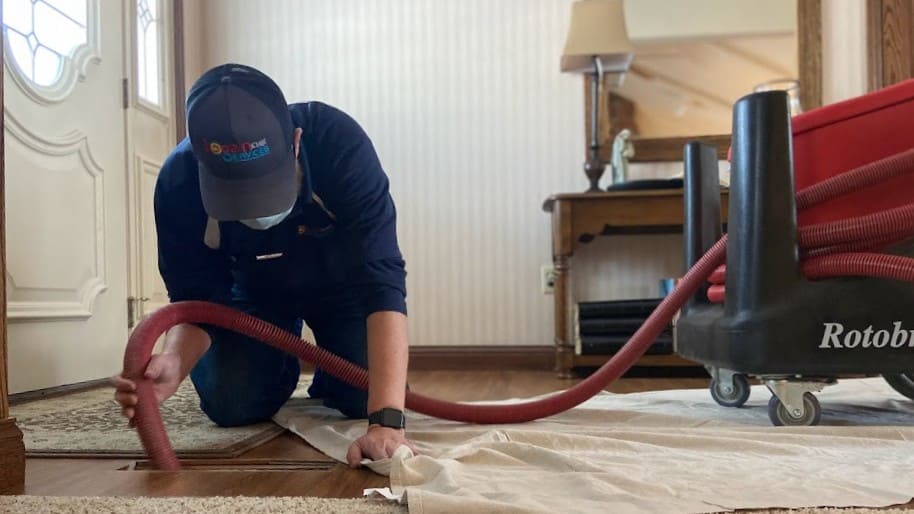Logan Services HVAC technician cleaning air ducts.