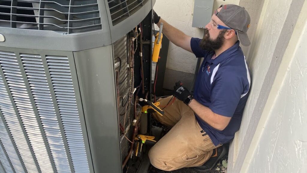 Logan Services HVAC service technician performing heat pump maintenance.