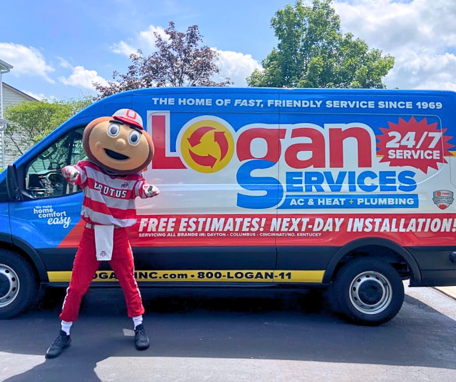 Brutus Buckeye posing with Logan Services van.