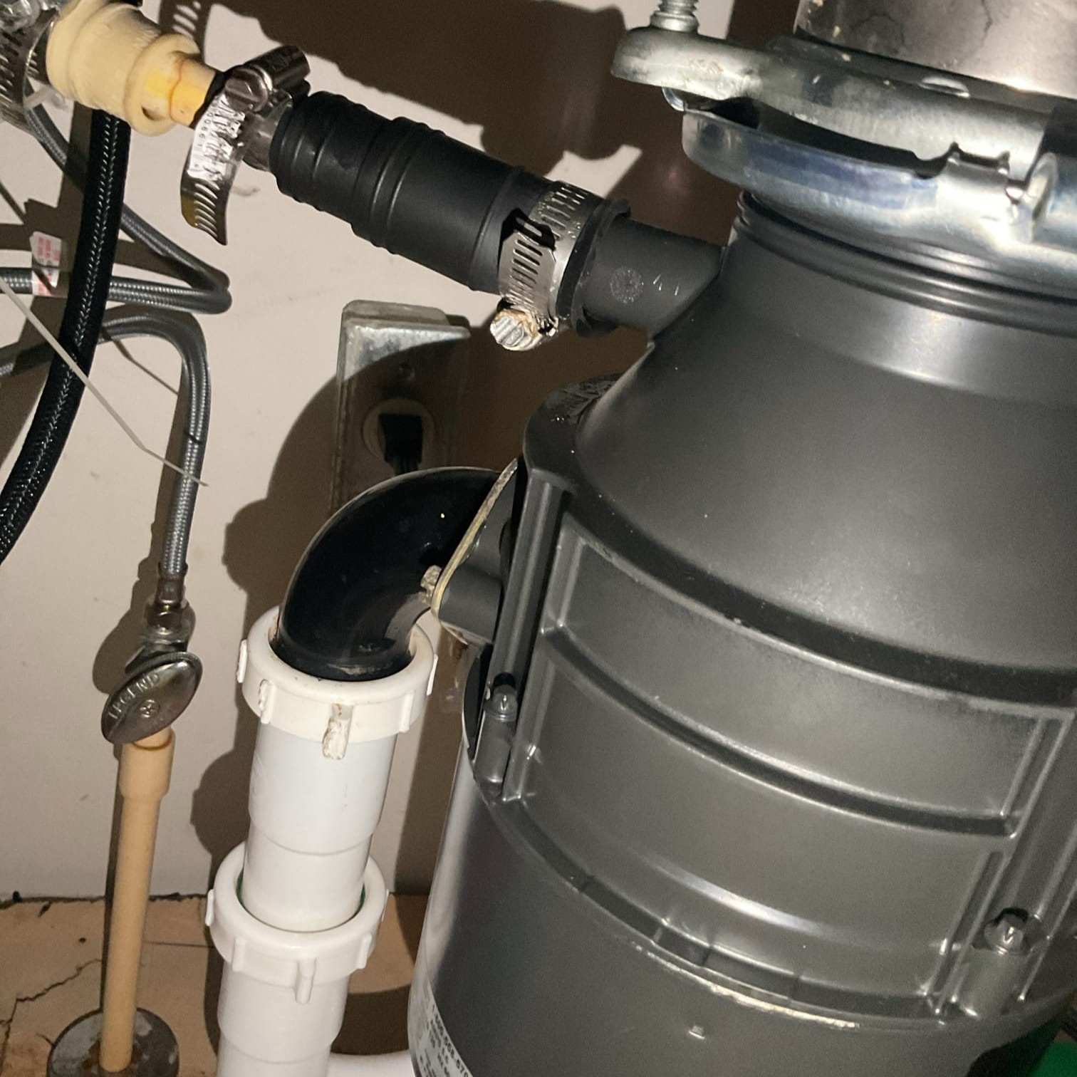 Under kitchen sink pipes - leak repaired by Logan Services.