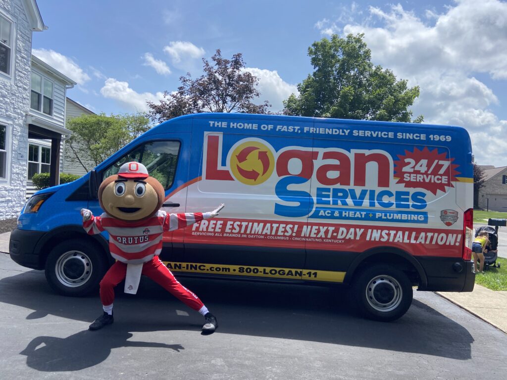 Ohio State University mascot Brutus posing with Logan Services van.