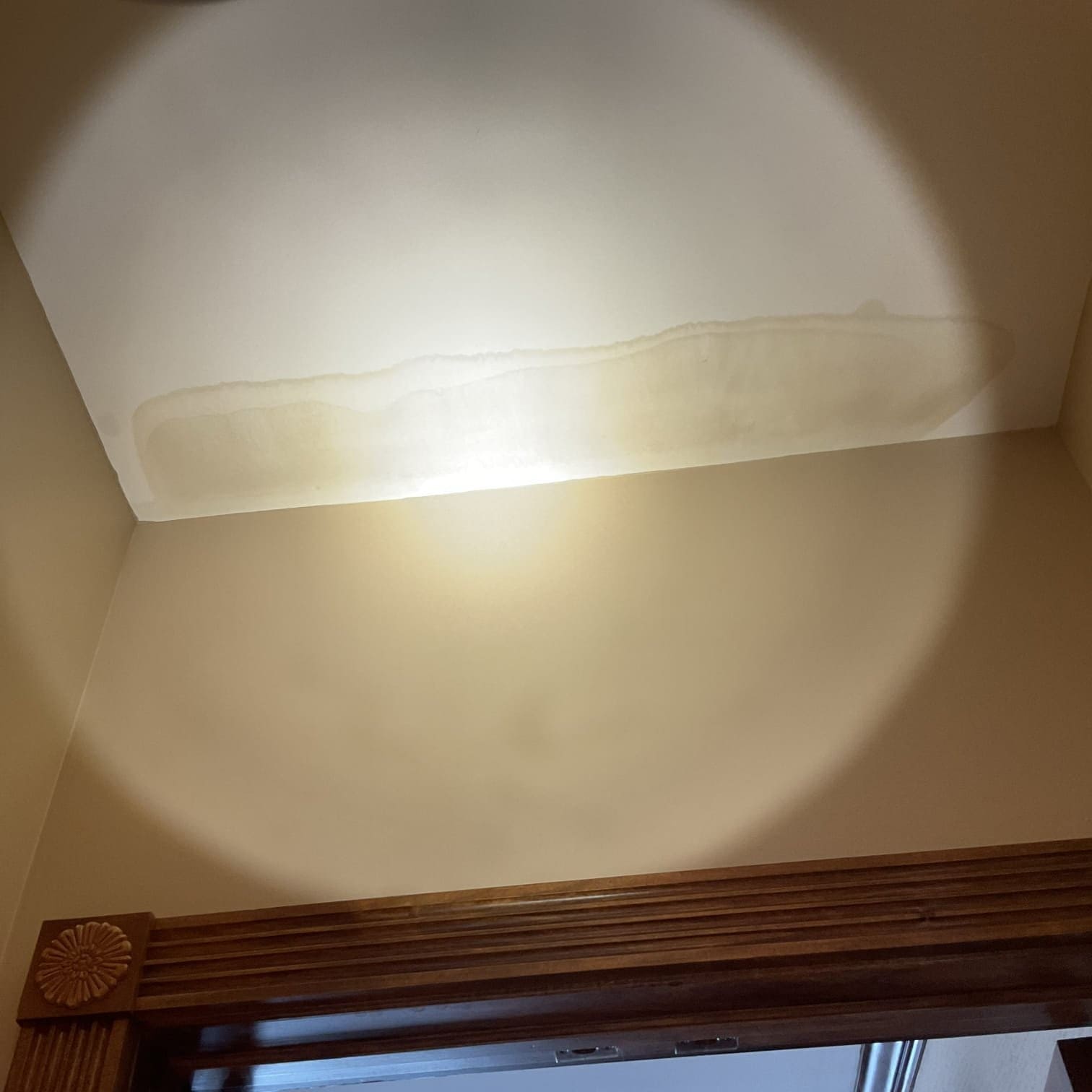 Water spot on ceiling caused by bathtub leak.