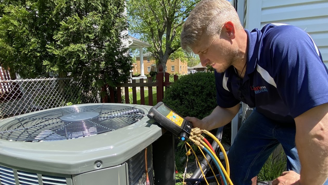 Logan Services technician installing Trane AC unit.