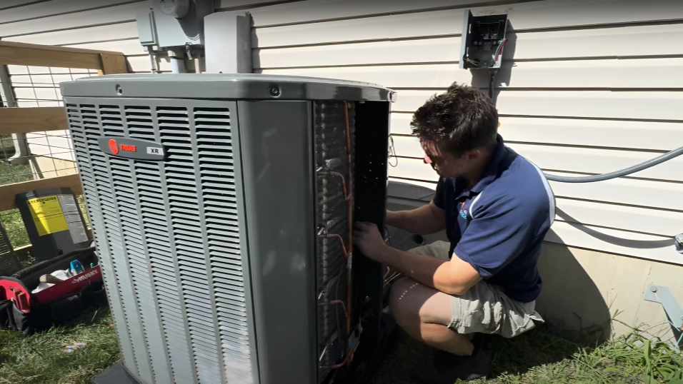 Logan Services technician installing Trane XR air conditioning unit.