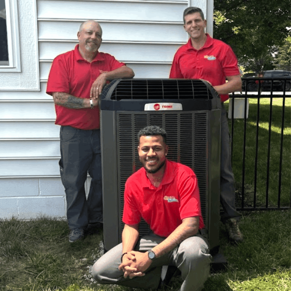 Logan Services HVAC technicians posing with Trane AC unit