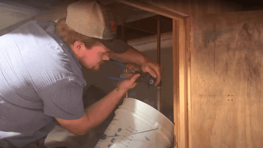 Logan Services plumber repairing hidden pipe leak.