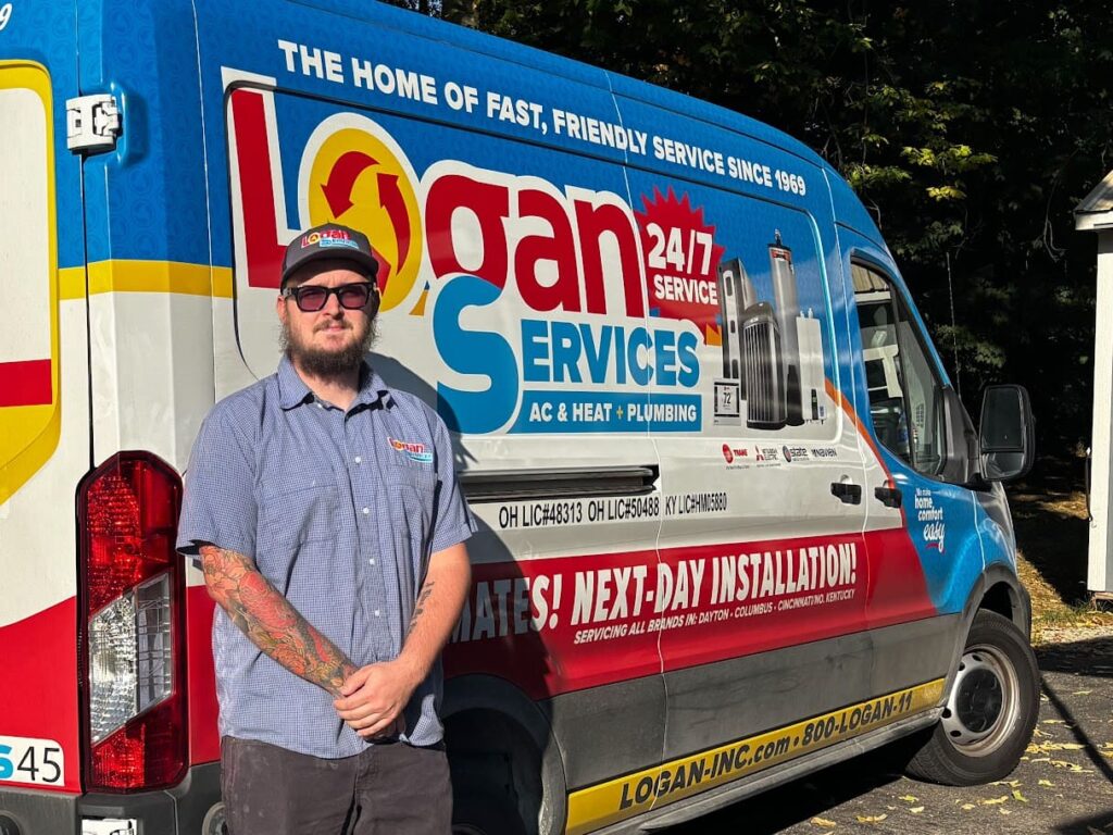 Logan Services Plumber posing with van