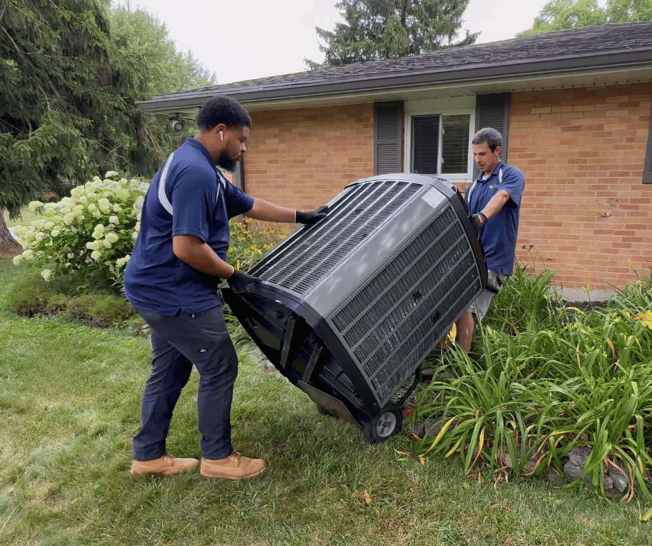 Logan Services HVAC technicians replacing AC unit.