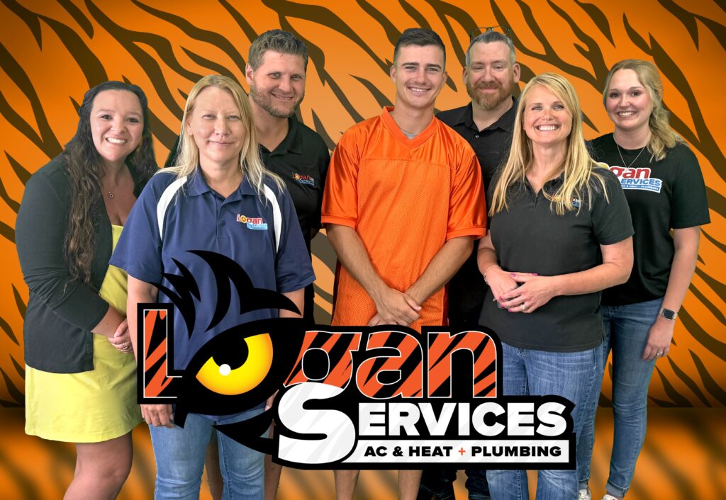 Evan McPherson posing with Logan Services team members.