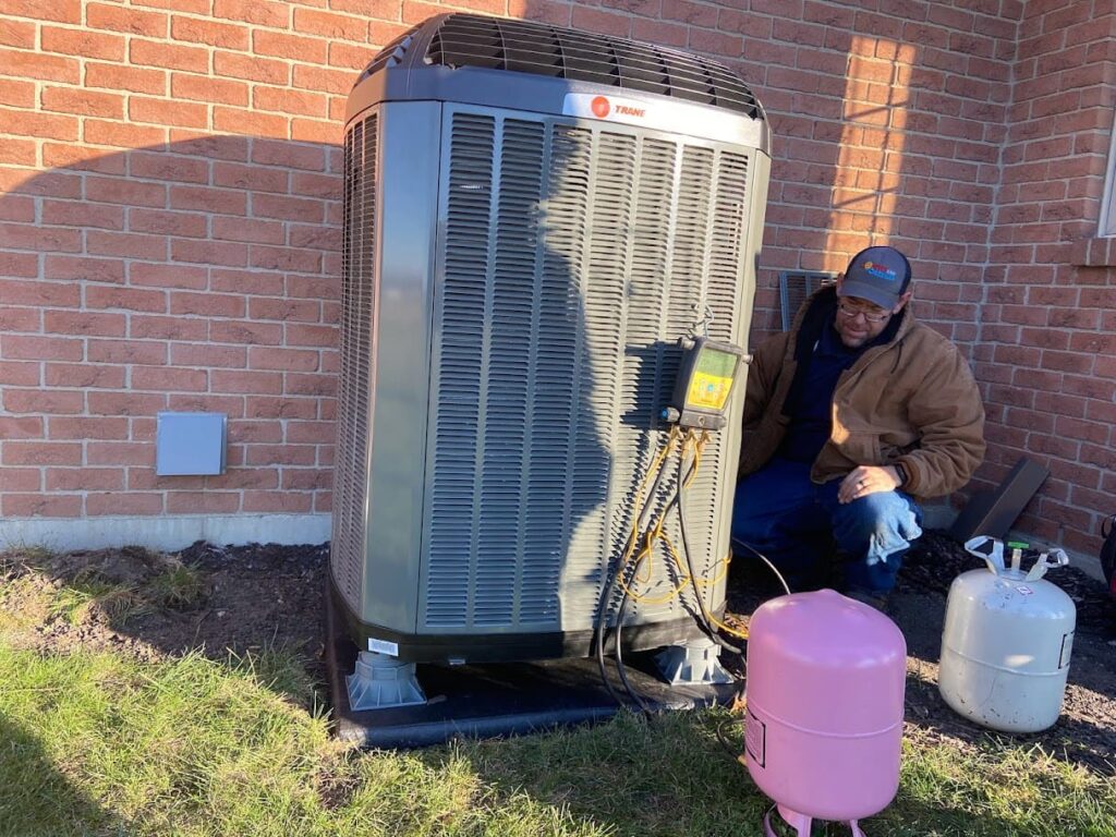 Logan Services HVAC technician installing heat pump.
