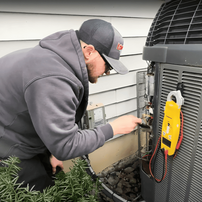 Logan Services HVAC technician performing Trane tune-up.