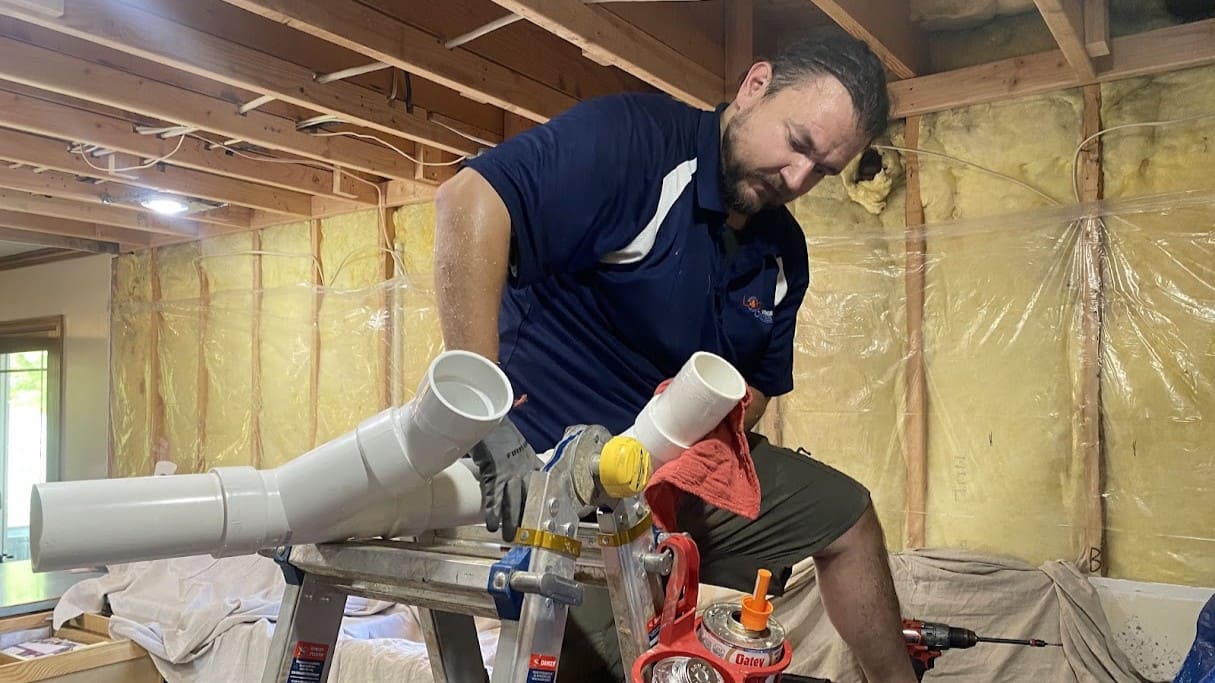 Logan Services plumber working on whole-home re-pipe.