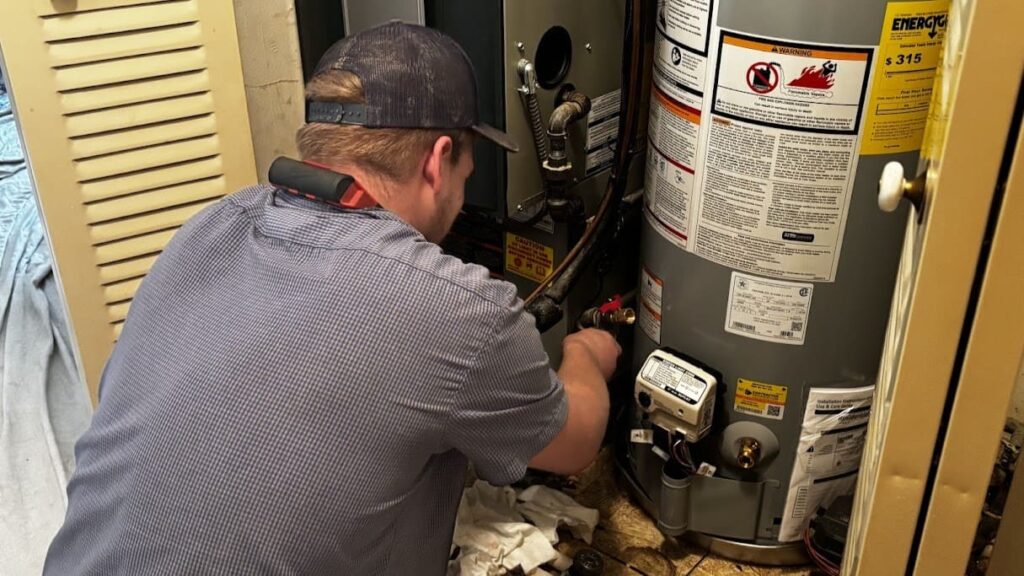 Logan Services plumber installing State tank water heater.