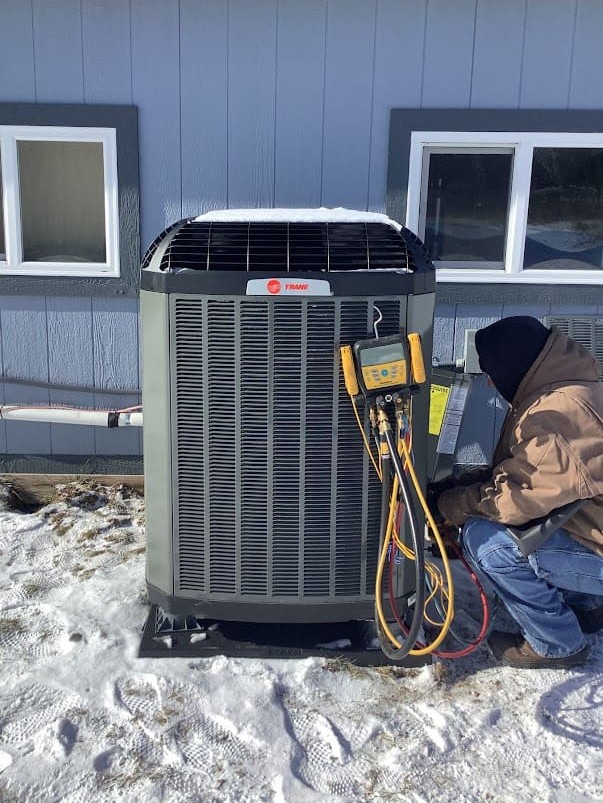 Logan Services HVAC Technician repairing heat pump