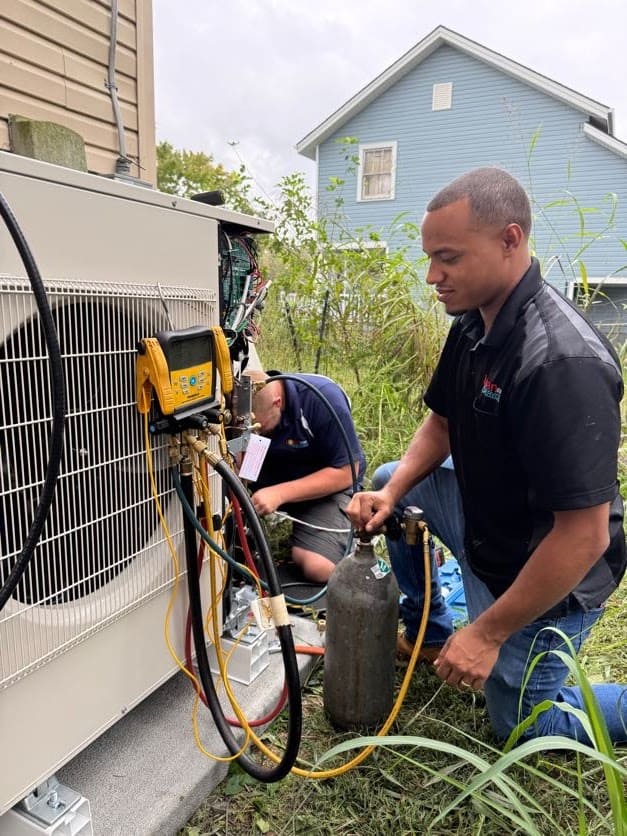 Logan Services HVAC technicians installing ductless HVAC system for Habitat for Humanity - 2024