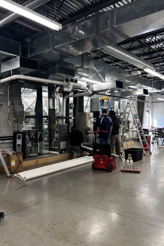 Logan Services HVAC installation apprentices learning how to install Trane furnaces.