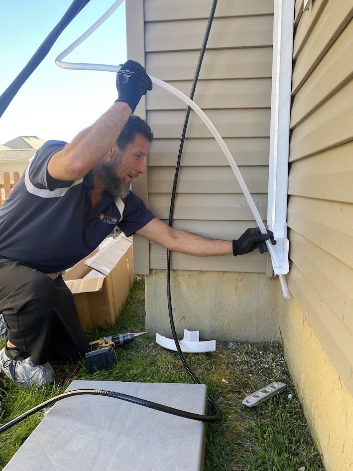 Logan Services HVAC technician installing ductless system.