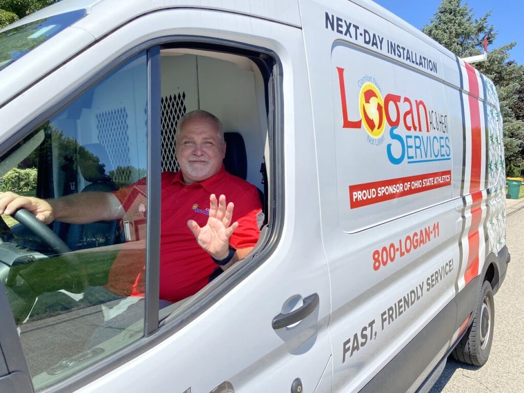 Logan Services HVAC technician in Buckeyes-inspired Logan Services van.