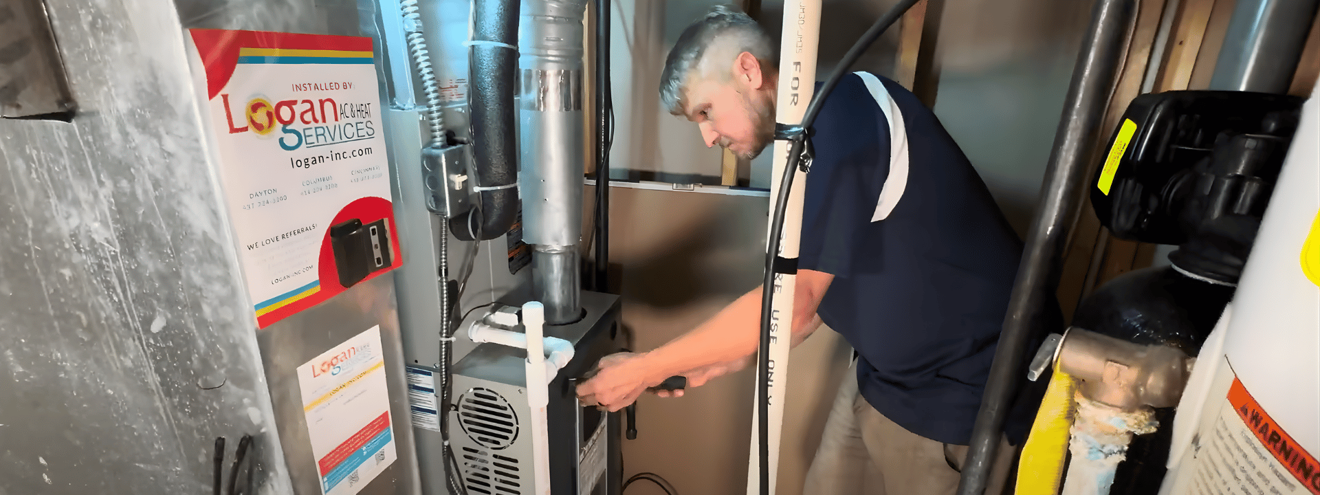 Logan Services HVAC technician installing a Trane furnace in a Dayton home.