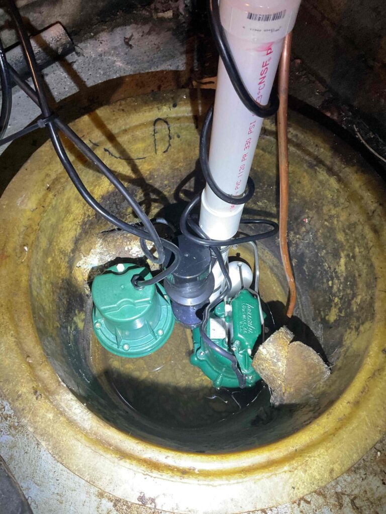 Sump pump installed in Columbus home by Logan Services plumbers.