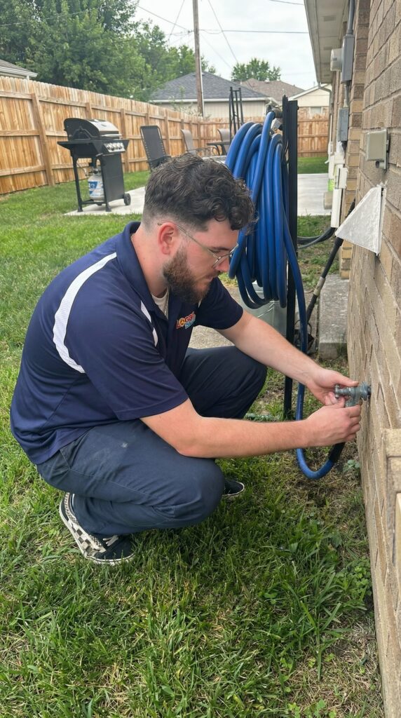 Logan Services plumber inspecting hose bib
