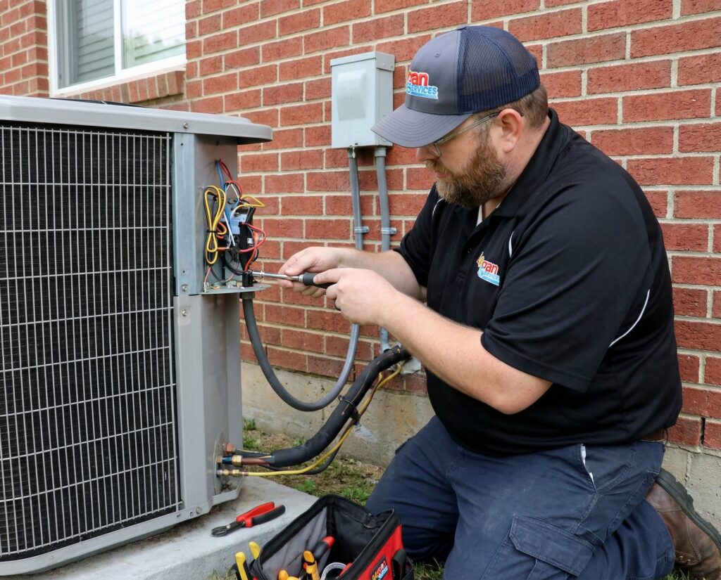 Logan Services HVAC technician repairing Cincinnati AC unit