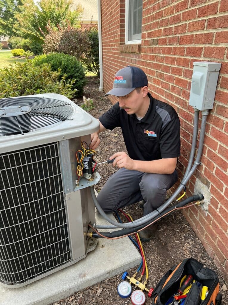 Logan Services HVAC technician repairing AC unit