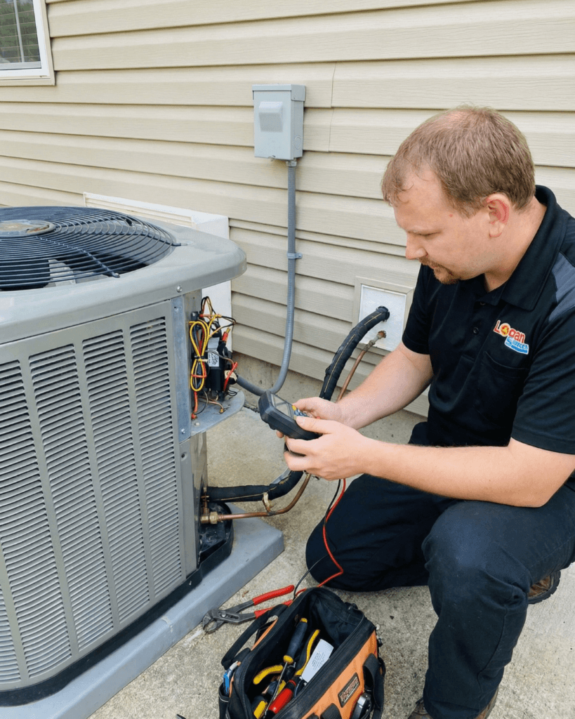 Logan Services HVAC technician performing repair