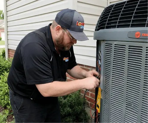 Logan Services HVAC technician performing Trane AC tune up