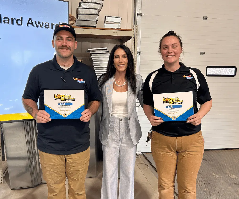 Company president Ashley posing with Logan Services employees