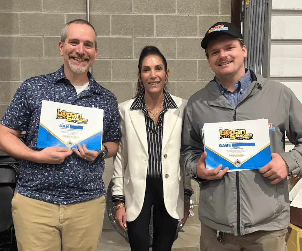 Company president Ashley posing with Logan Services employees