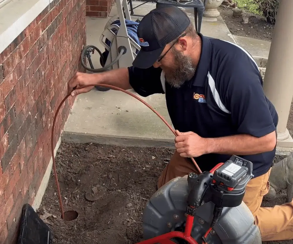 Logan Services plumber inspecting main drain line for clogs
