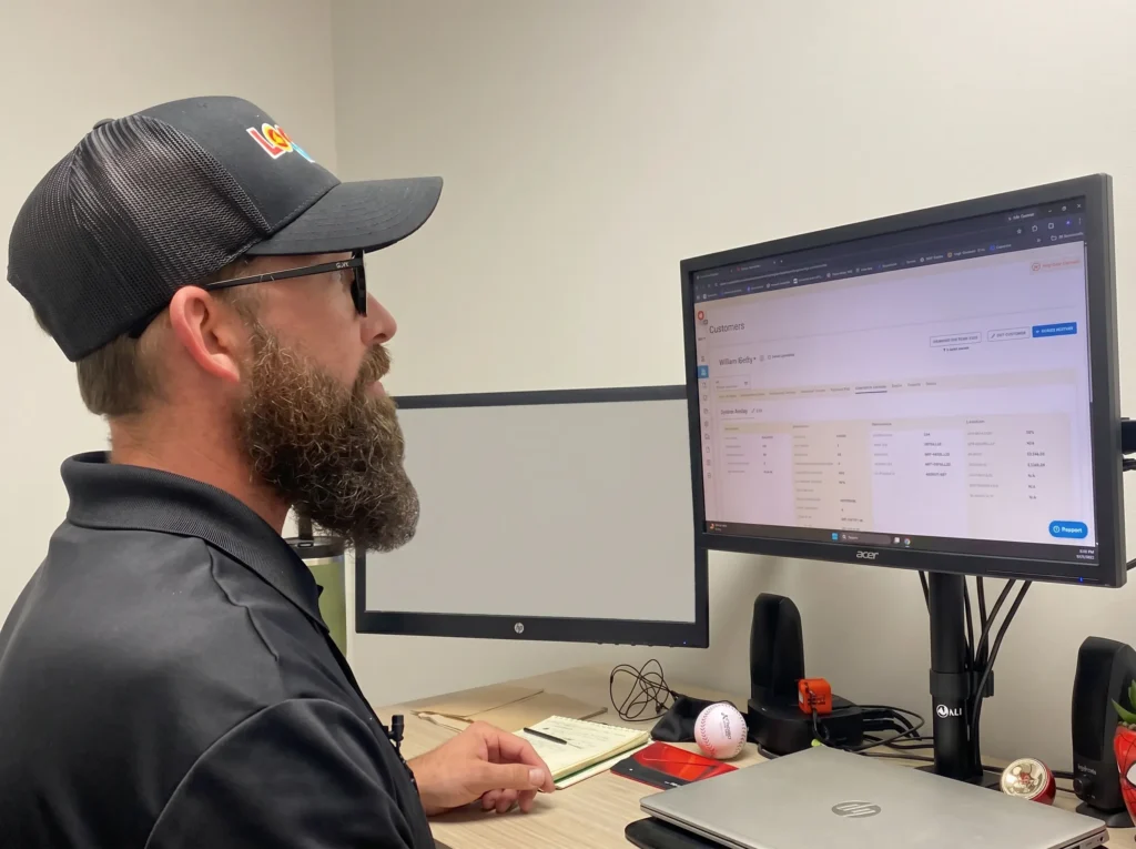Logan Services HVAC technician performing remote diagnostics.