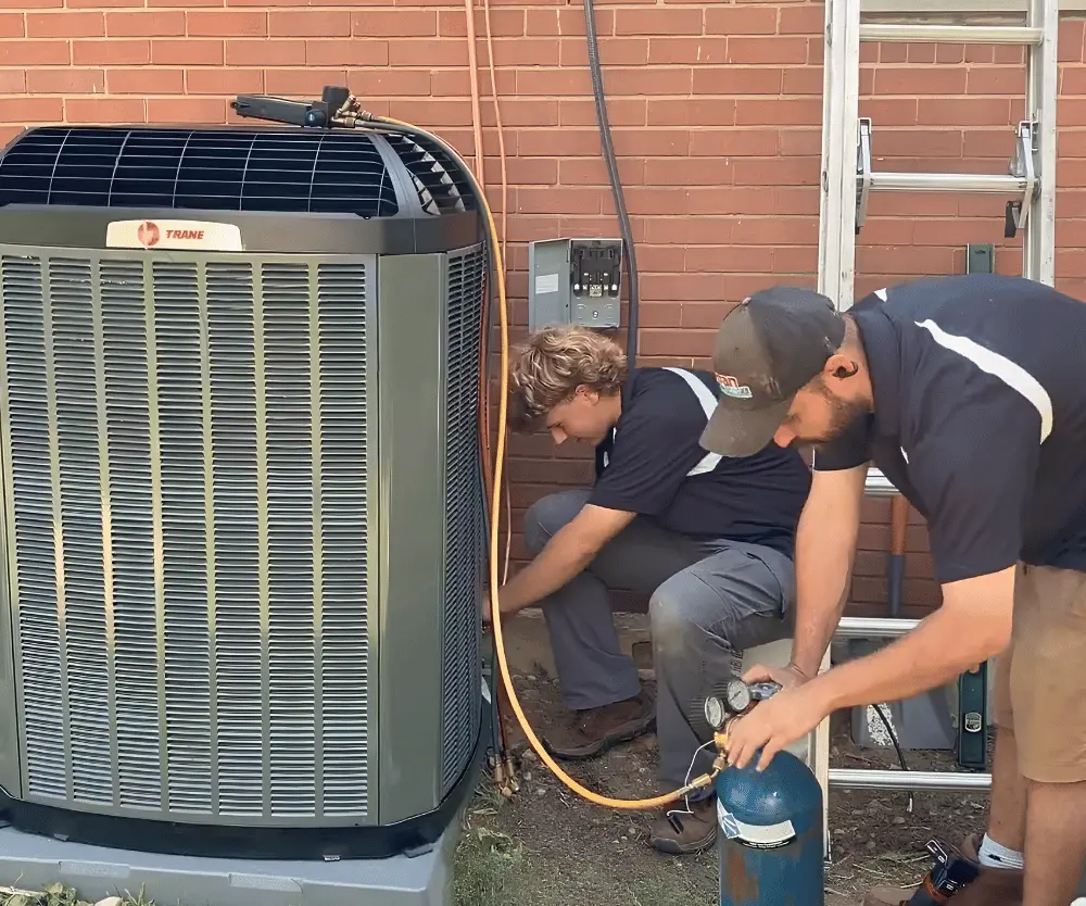 Logan Services HVAC installers filling refrigerant
