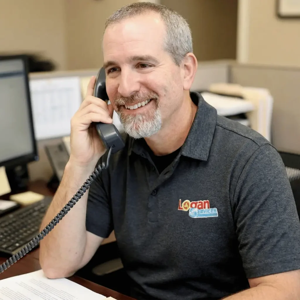 Logan Services employee on the phone with a customer.